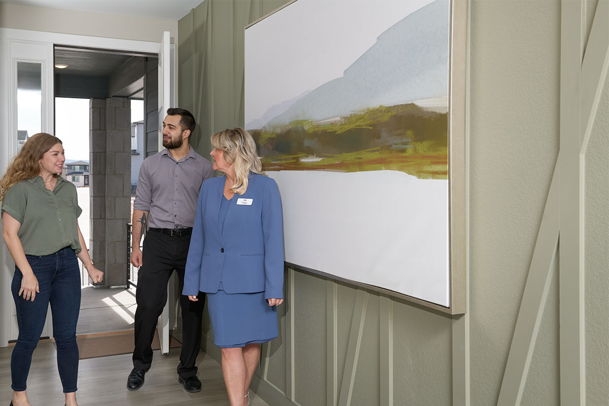 A couple and their real estate agent touring a home