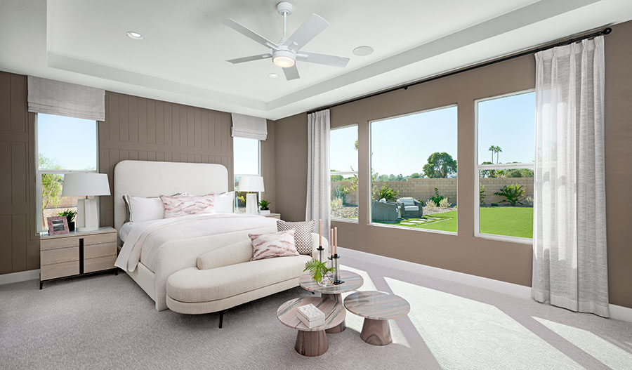 A stunning primary suite with tasteful decor and large windows