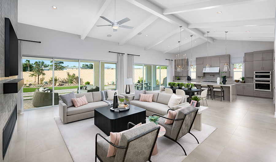 An open-concept great room and kitchen with large windows