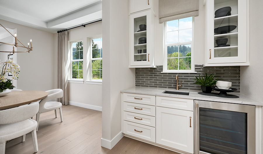 A butler's pantry with a sink, cabinetry, and a cooler