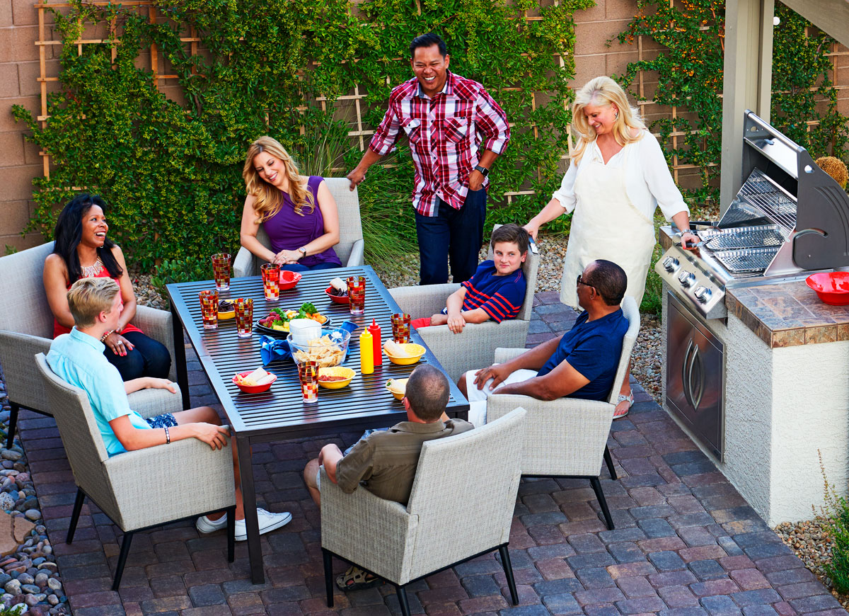 outdoor kitchen gathering family and friends enjoying an outdoor kitchen