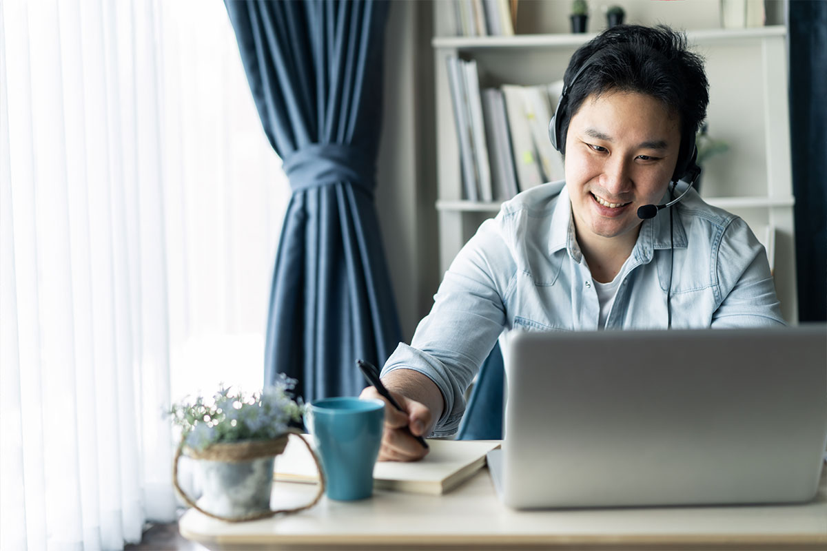 Young man researching the new homes vs resale debate on his computer
