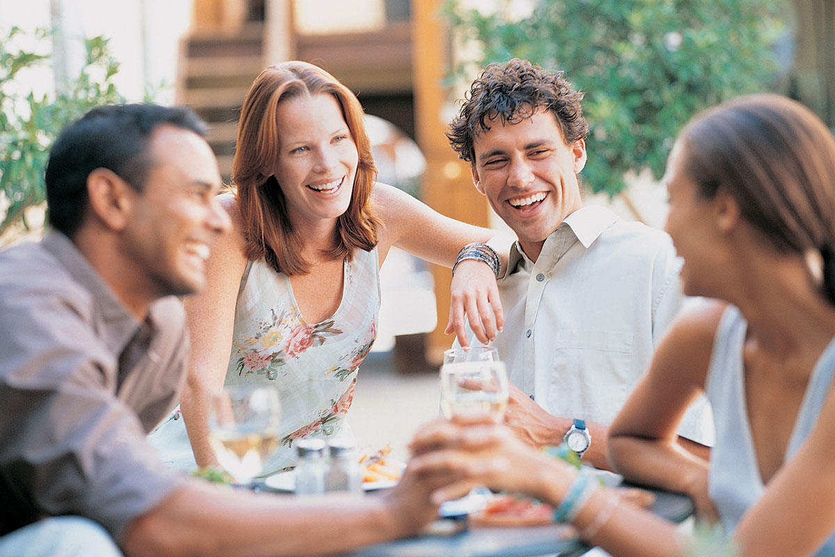 Two couples hanging out and laughing