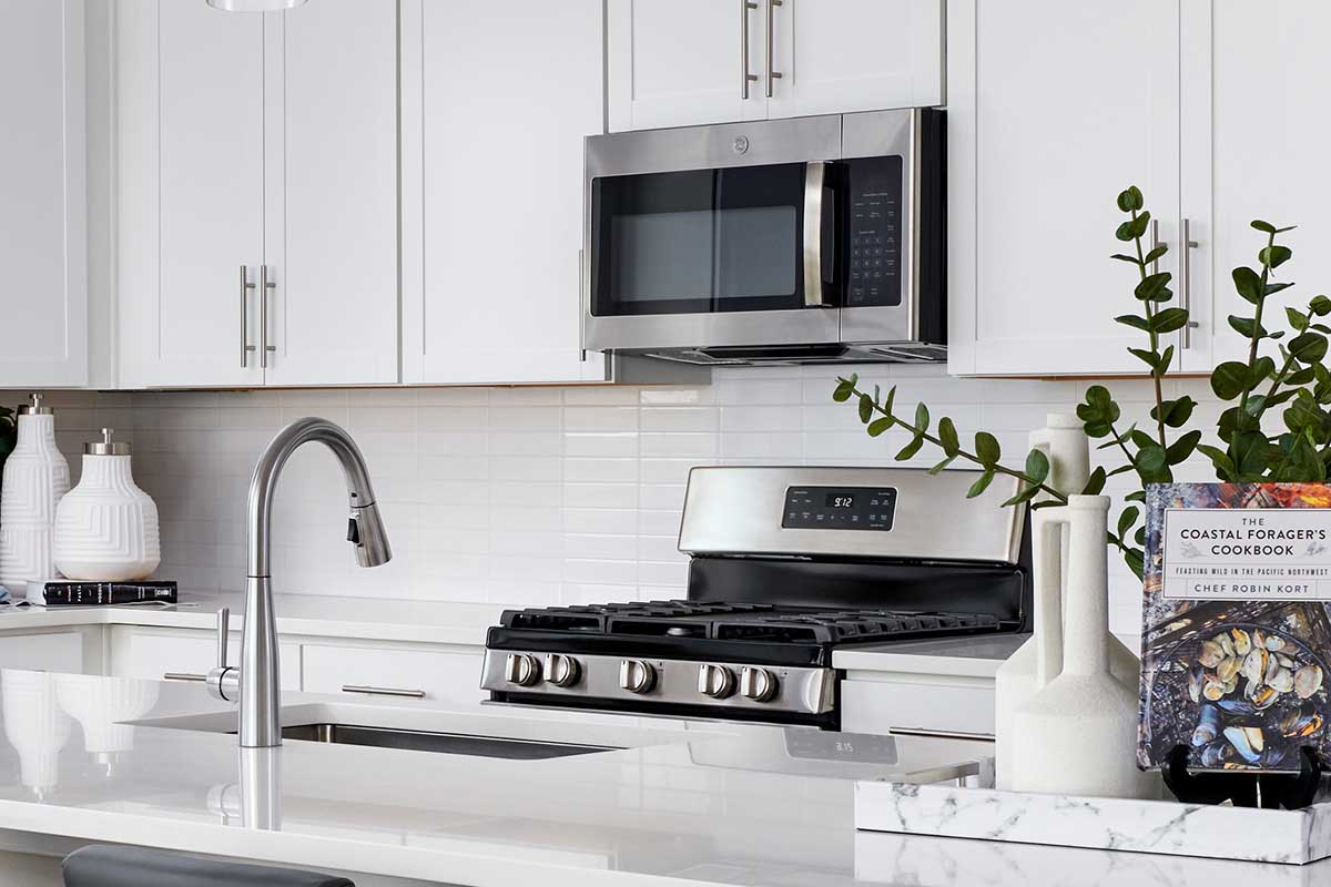 bright kitchen with white quartz kitchen countertops and white cabinets