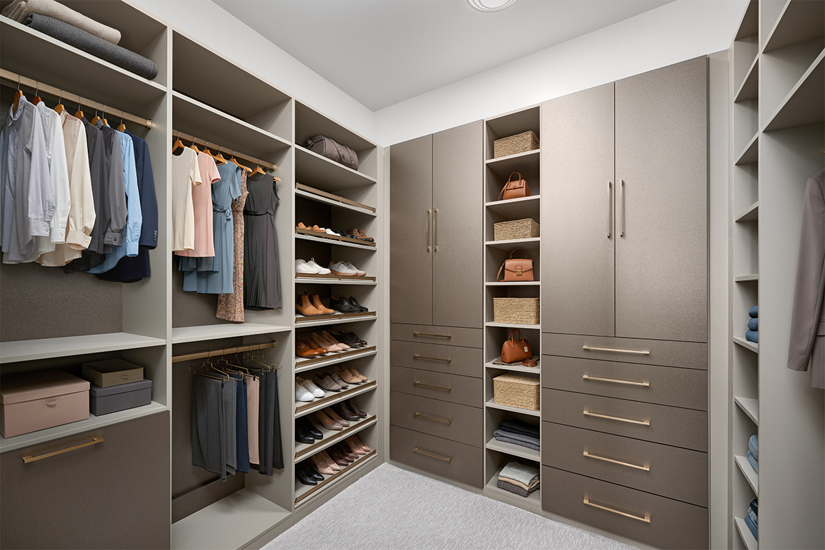 large walk-in closet with drawers and cabinets for home storage