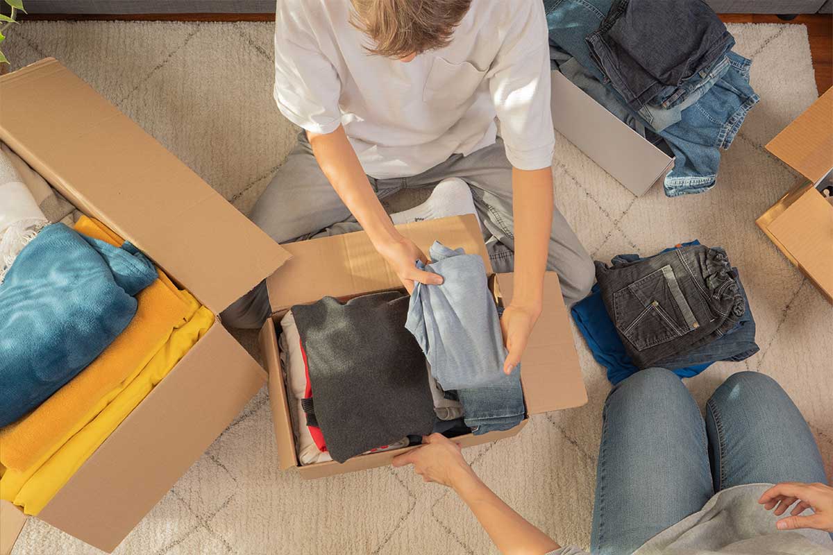 Overhead shot of a family packing up clothing in boxes
