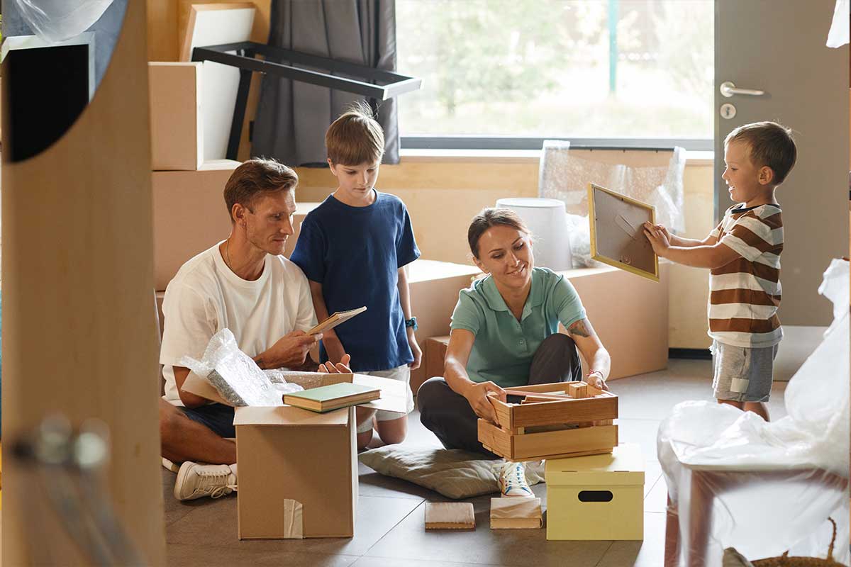 A family unpacking moving boxes in their new home