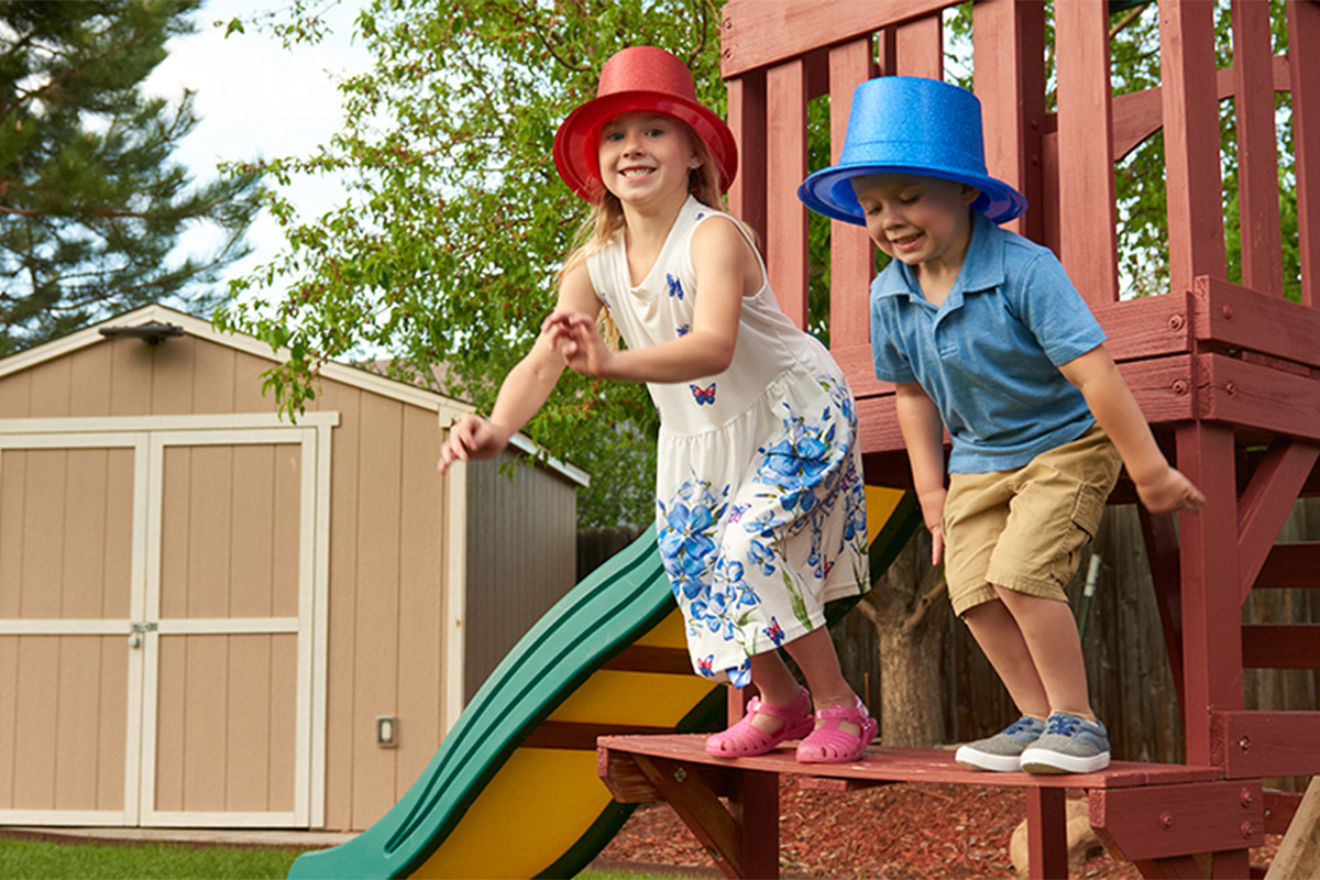 young boy and girl playing with red and blue hats