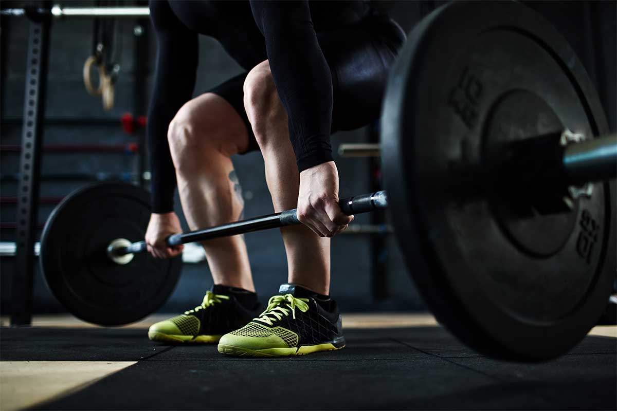 man lifting weights in a space designed for storage for recreational vehicles
