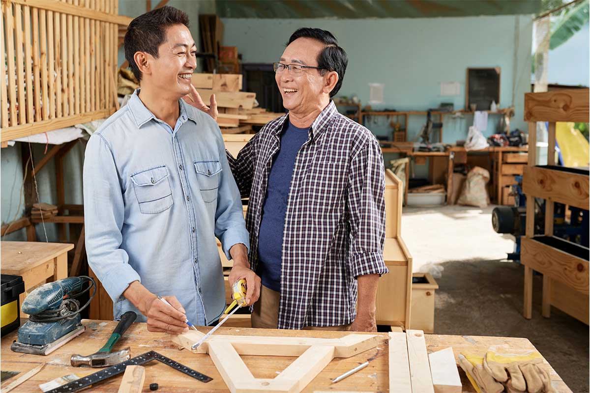 father and son setting up a workshop in their garage designed for storage for recreational vehicles