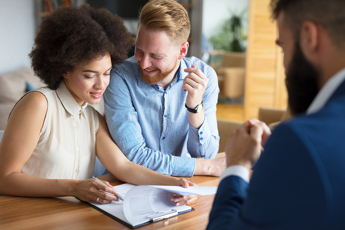 Young couple talking to estate agent