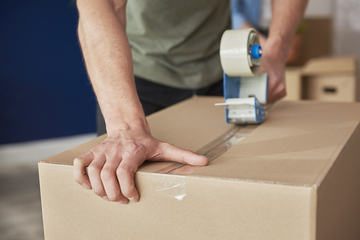 Detail of packing cardboard boxes while moving house