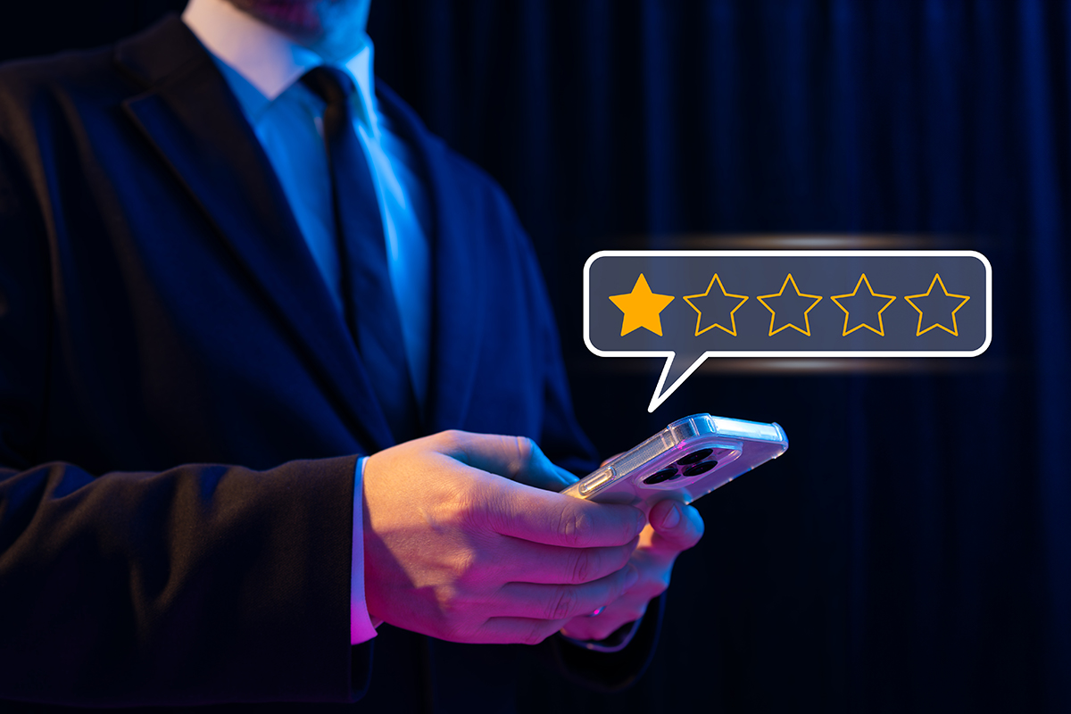 A person using a smartphone to give a one-star rating, representing customer dissatisfaction, negative feedback, and its impact on business reputation. Highlights online reviews and consumer opinions