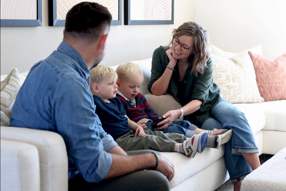 Family sitting on a couch in a loft area