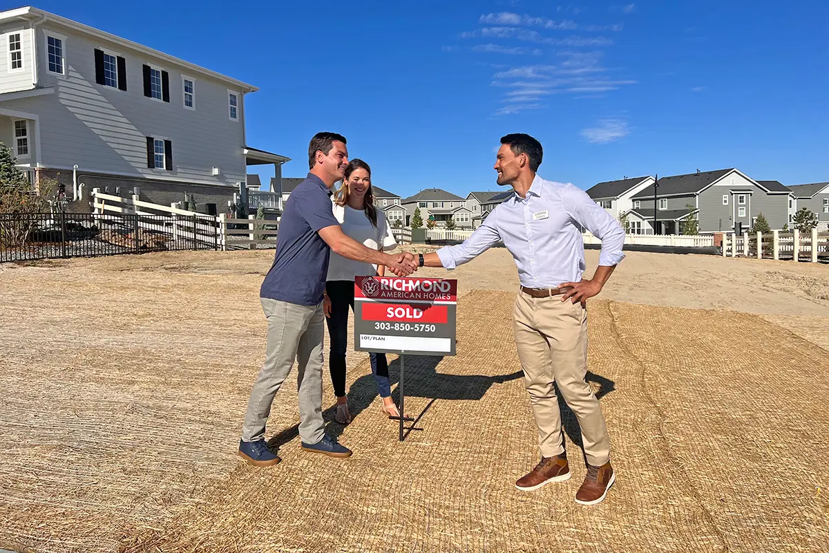 Couple shaking hands with a sales consultant