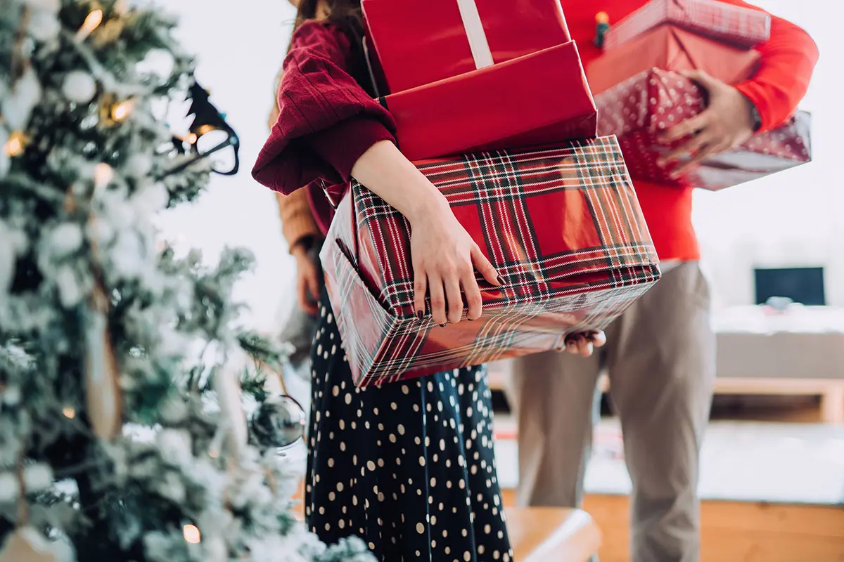 Person holding holiday gifts