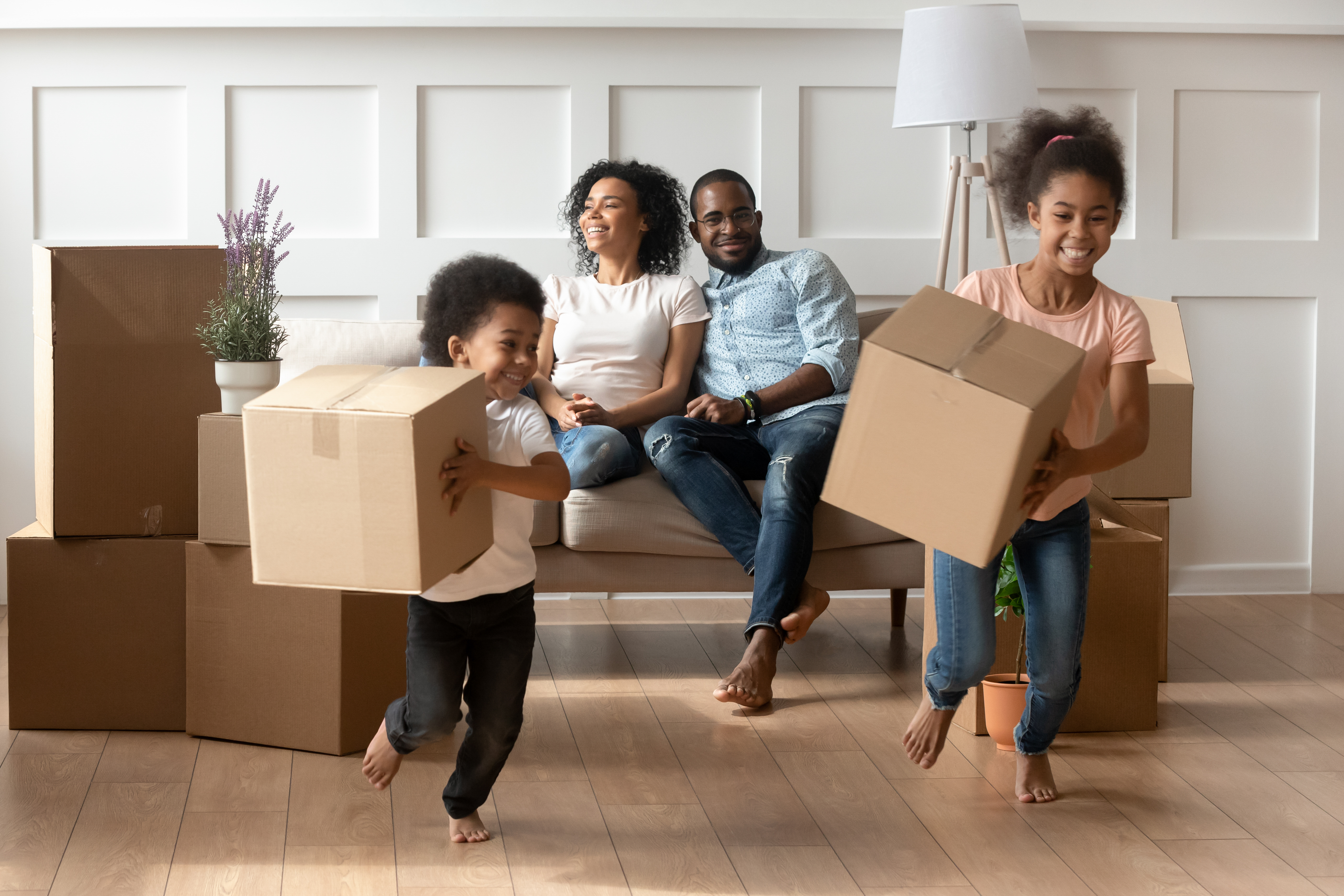 Family moving and children carrying boxes