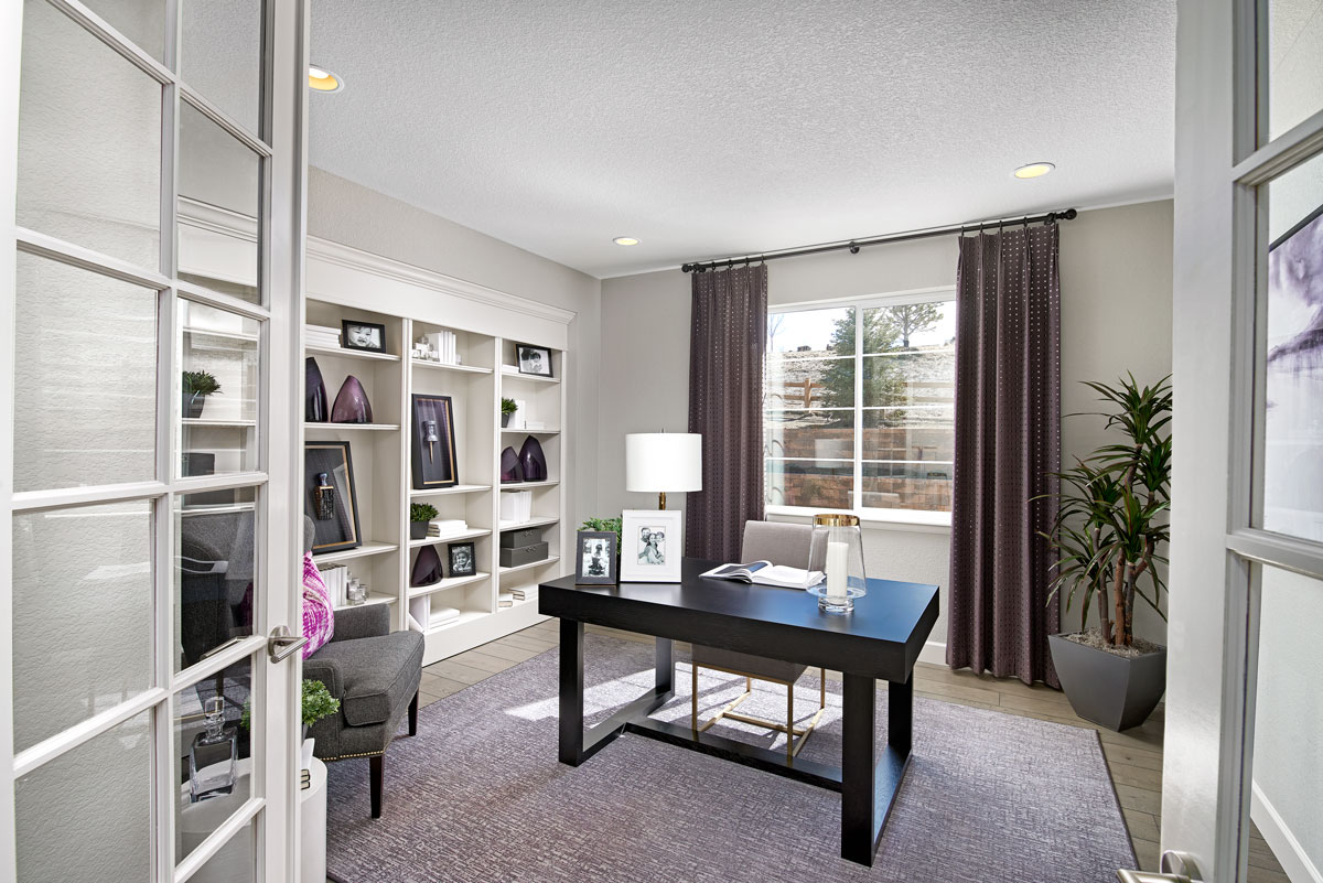 Home office/study with white cabinets, black desk and purple curtains