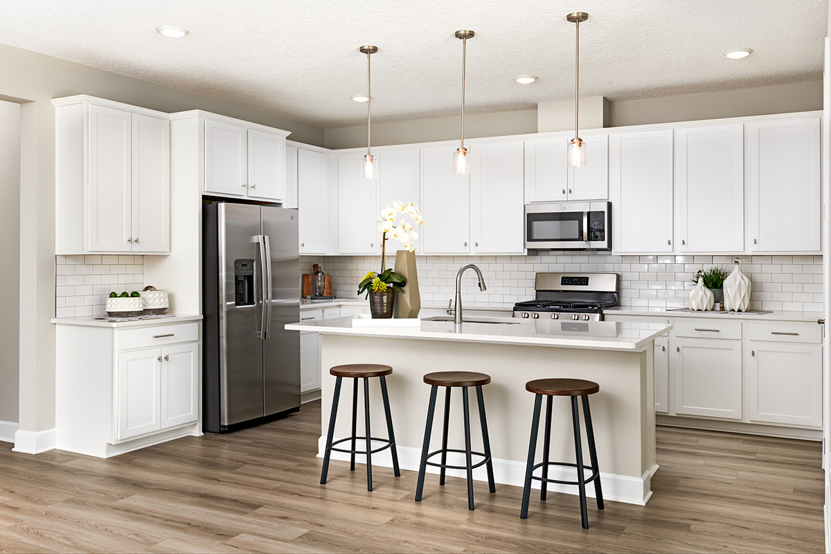 Cunningham floor plan kitchen with white cabinets and black handles