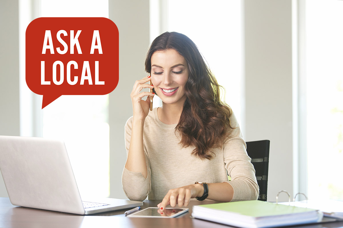 Woman on phone at desk with Ask a Local logo over top