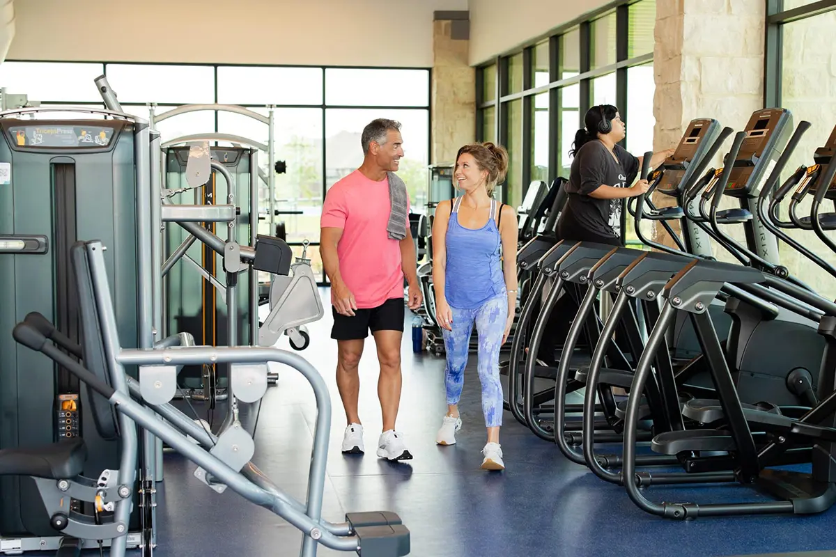 Man and woman talking at gym