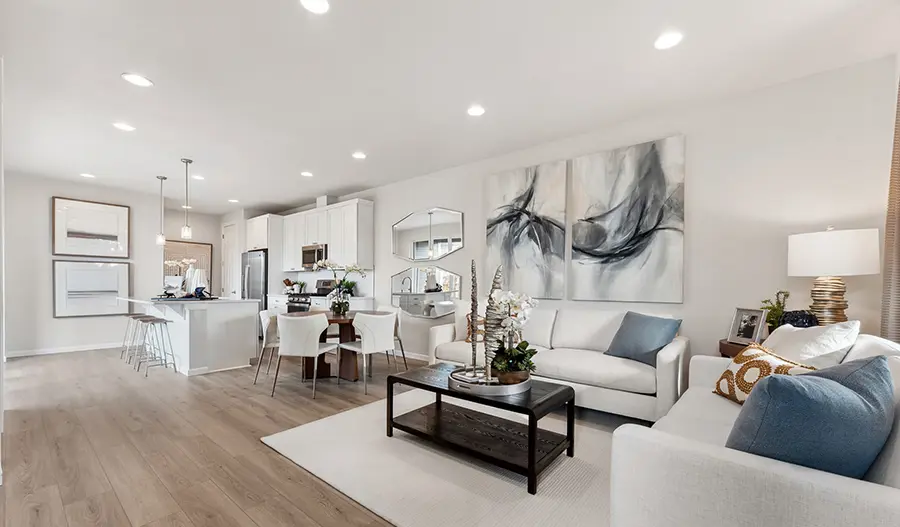 Relaxing great room with decorative throw pillows and a coffee table with a centerpiece