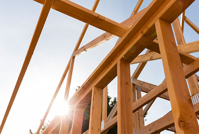 Framed house with sun and sky in the background