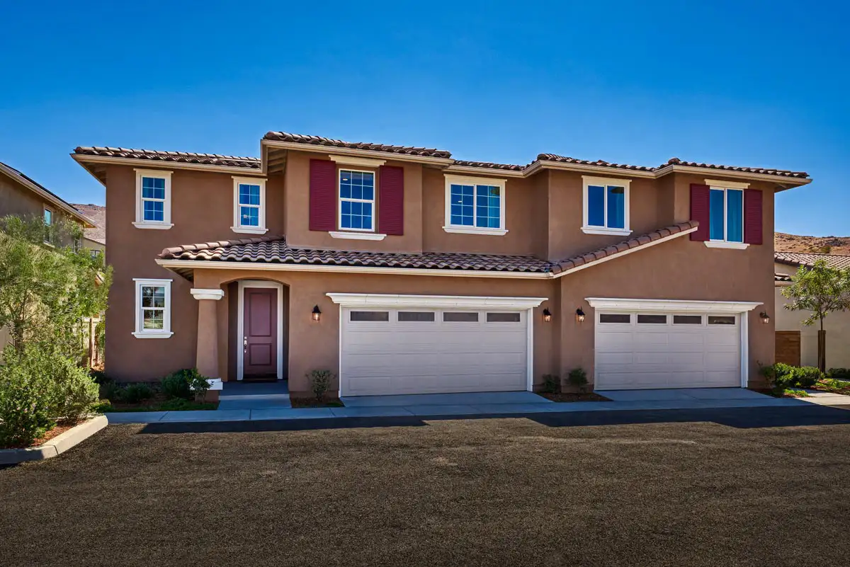 Two-story home with one front door and two two-car garage doors