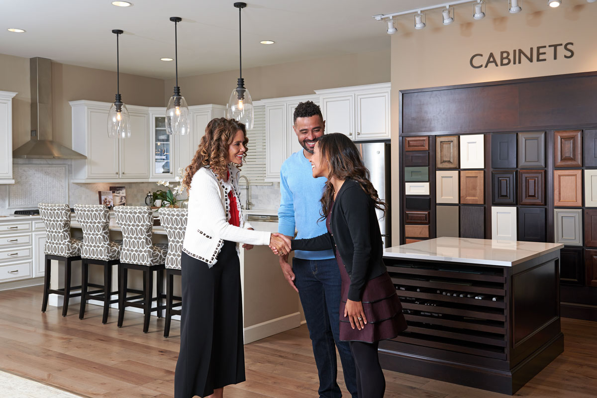 Design consultant greeting couple at the Home Gallery