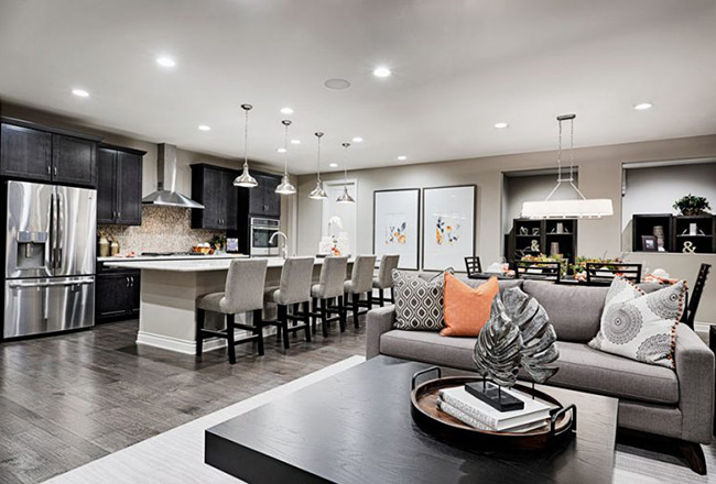 Coffee table and couch with kitchen with large island behind it