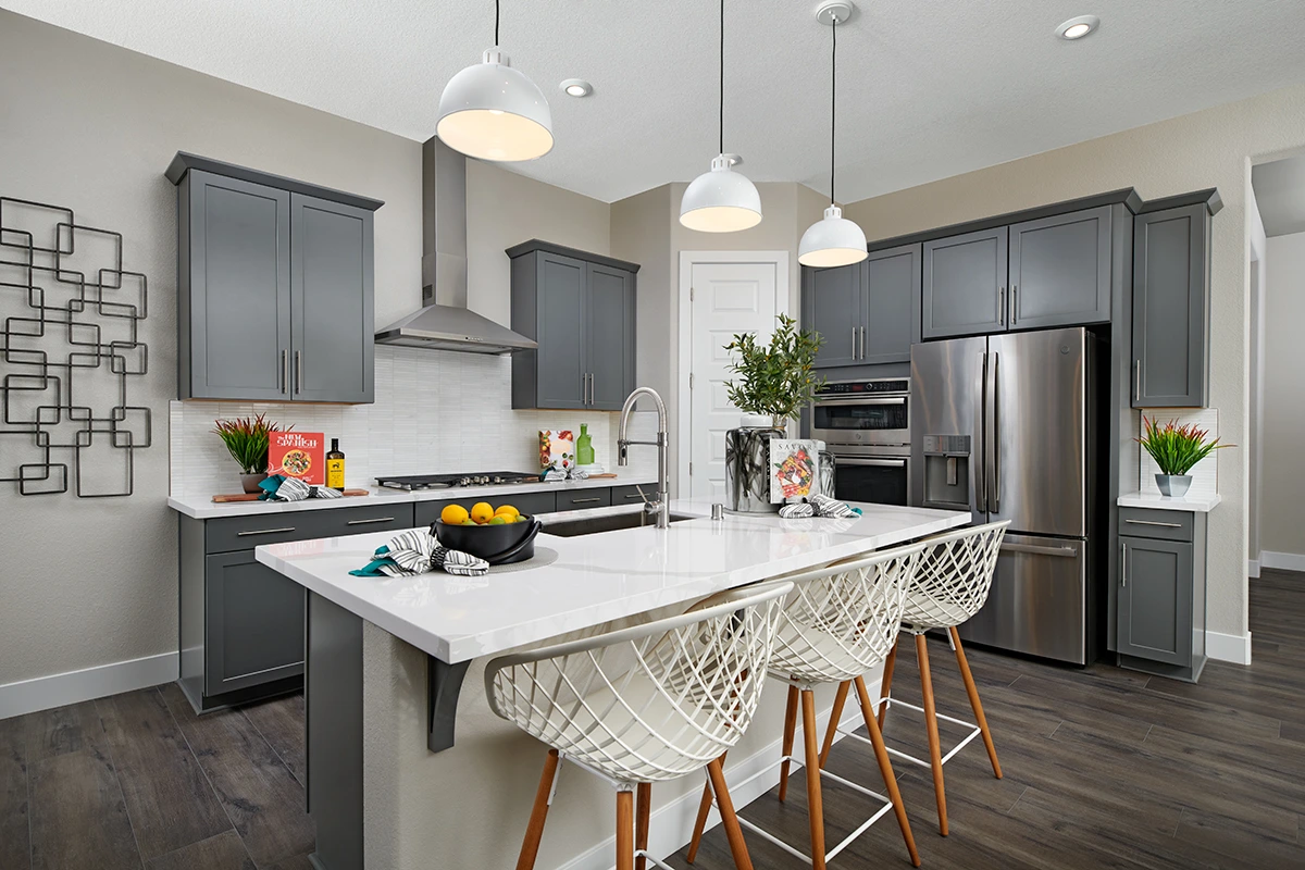 Kitchen with island, gas stove, double oven, and pantry door in corner