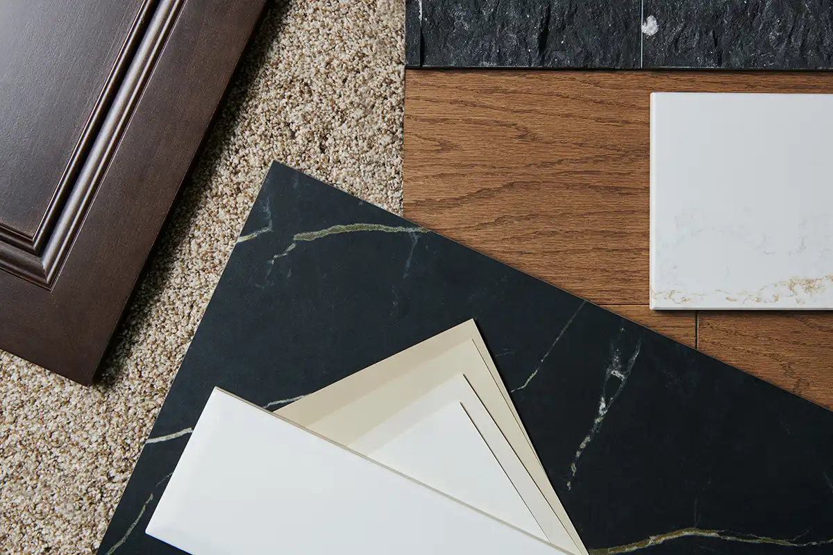 Bermuda Lines color studio samples laid on a table, including tiles, flooring, and a cabinet sample