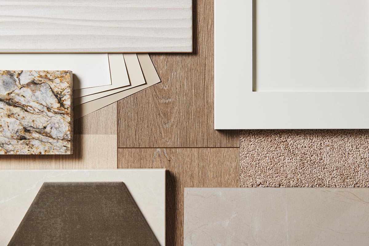 Nantuket Taupe color studio samples laid on a table, including tiles, flooring, and a cabinet sample