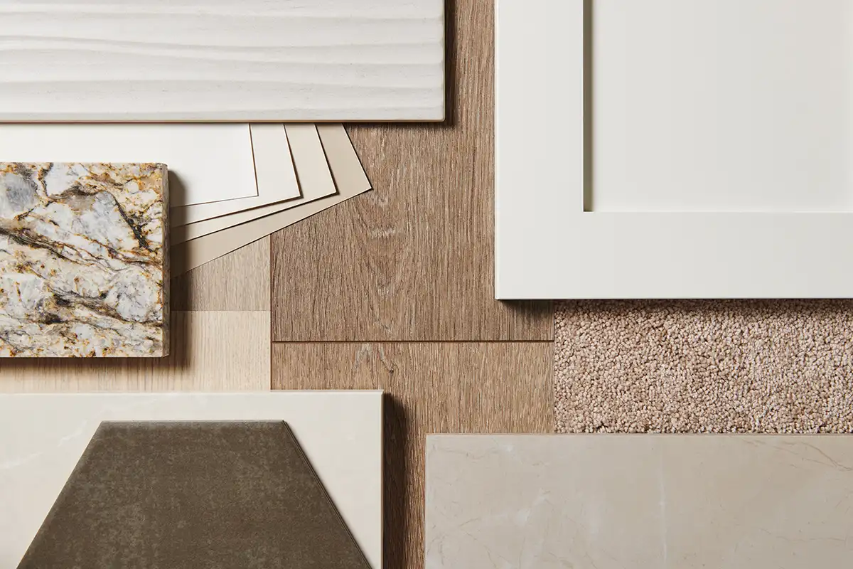 Nantuket Taupe color studio samples laid on a table, including tiles, flooring, and a cabinet sample
