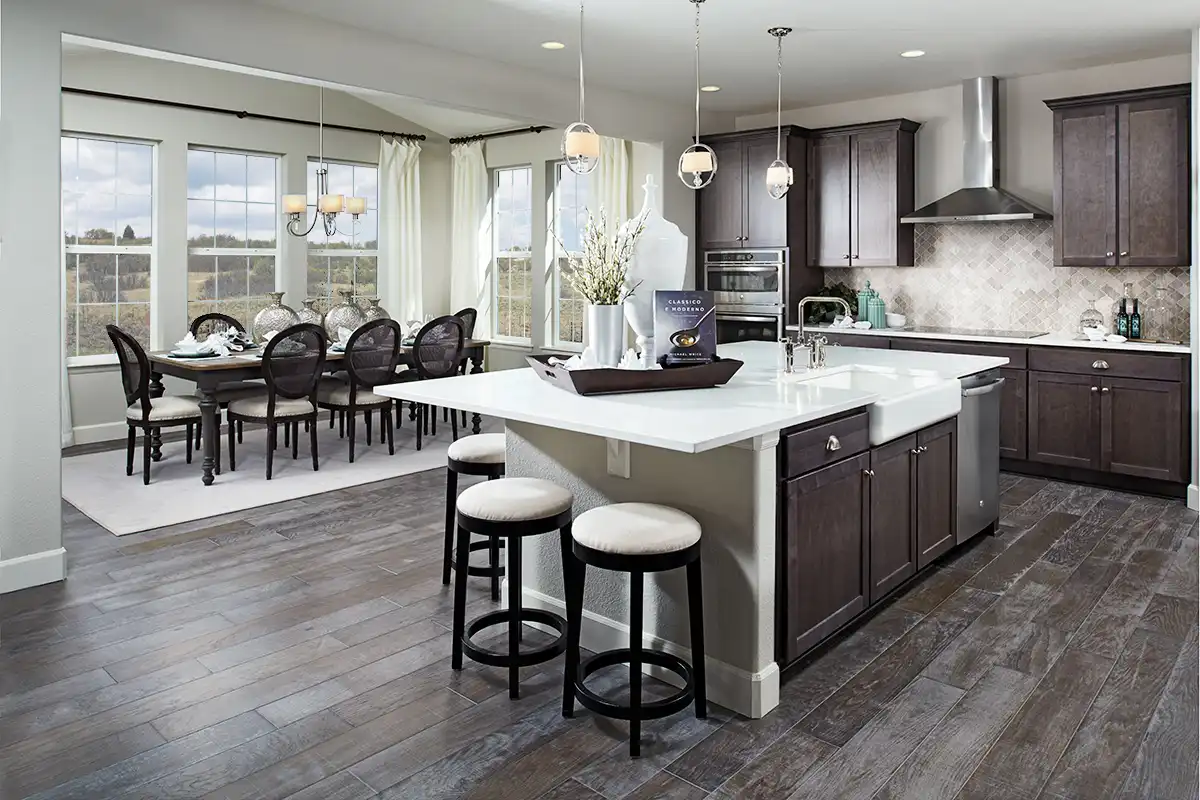 Kitchen with electric stove, large island with farmhouse sink, and diamond tile backsplash