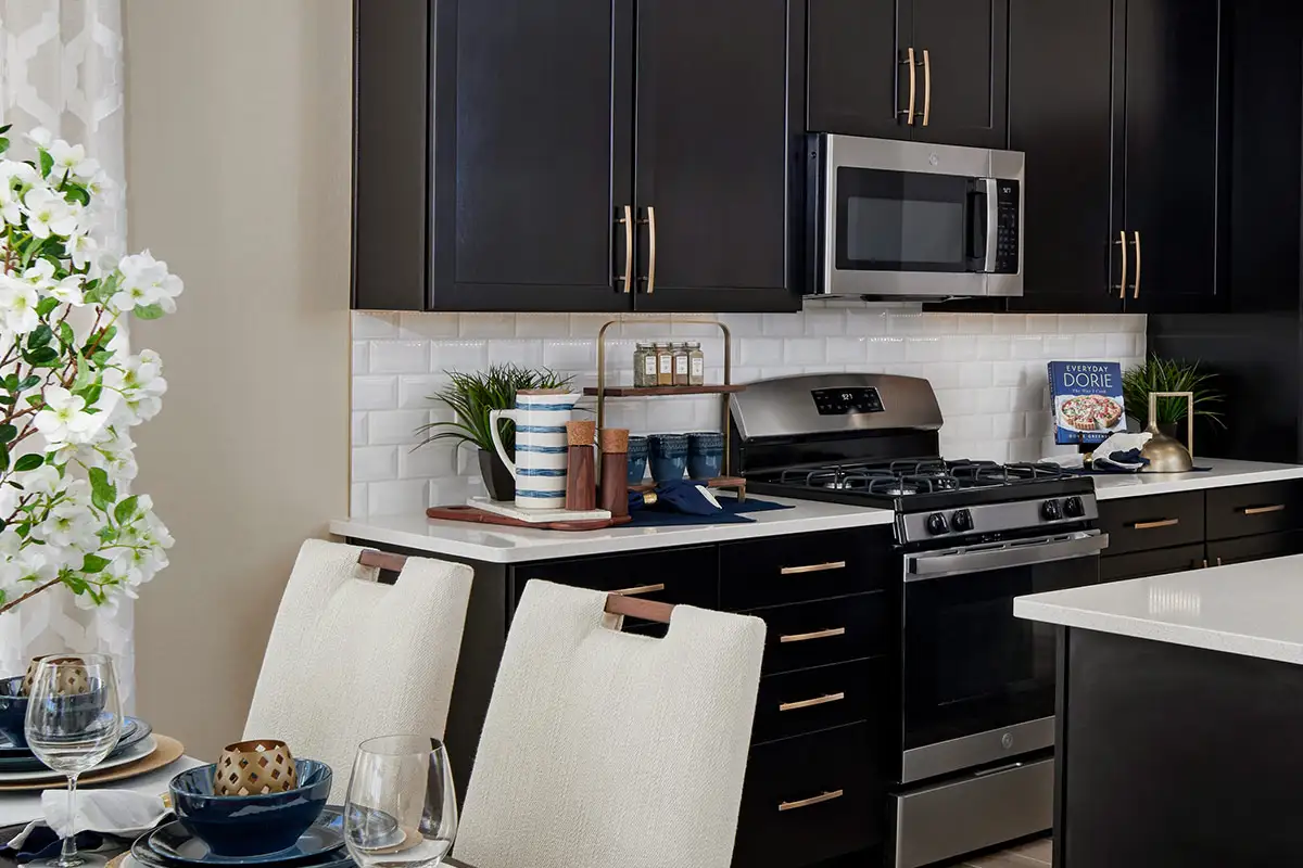 Kitchen with dark cabinets and brick-patterned backsplash