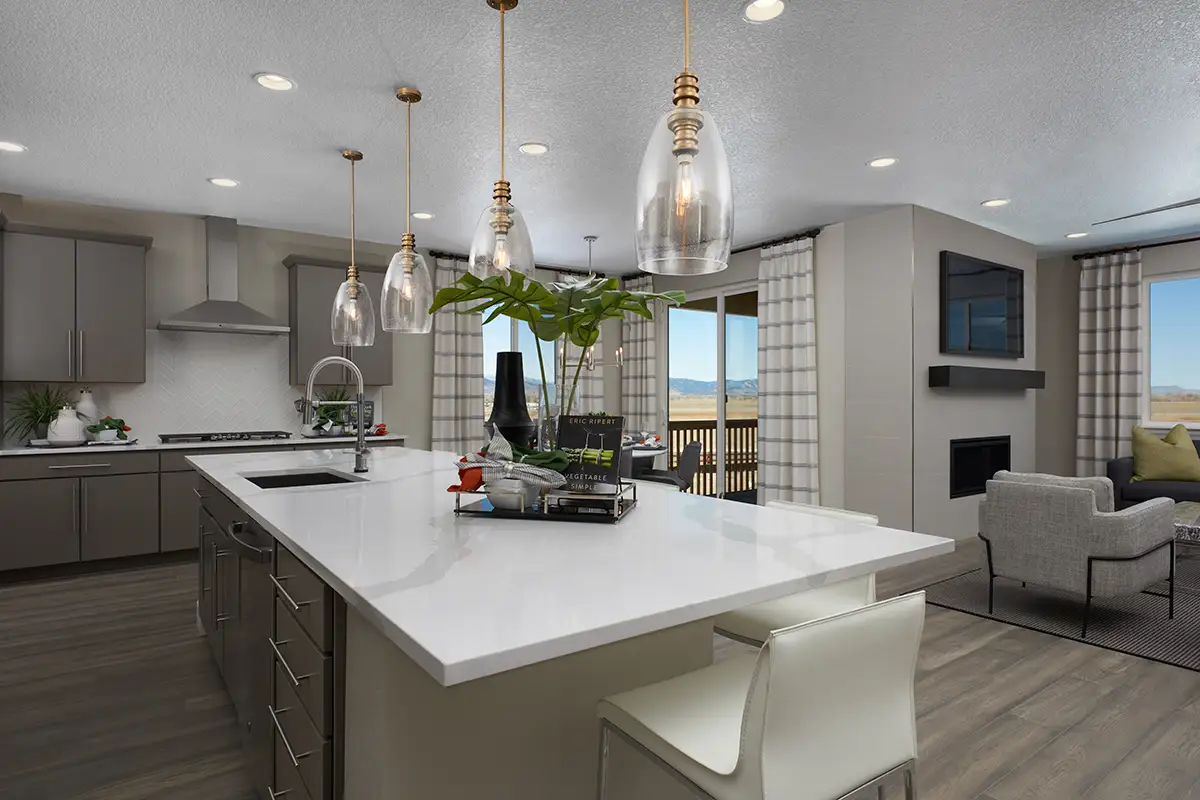 Large kitchen island with cabinets on wall in the background with chevron backsplash, as well as sliding doors to a back patio