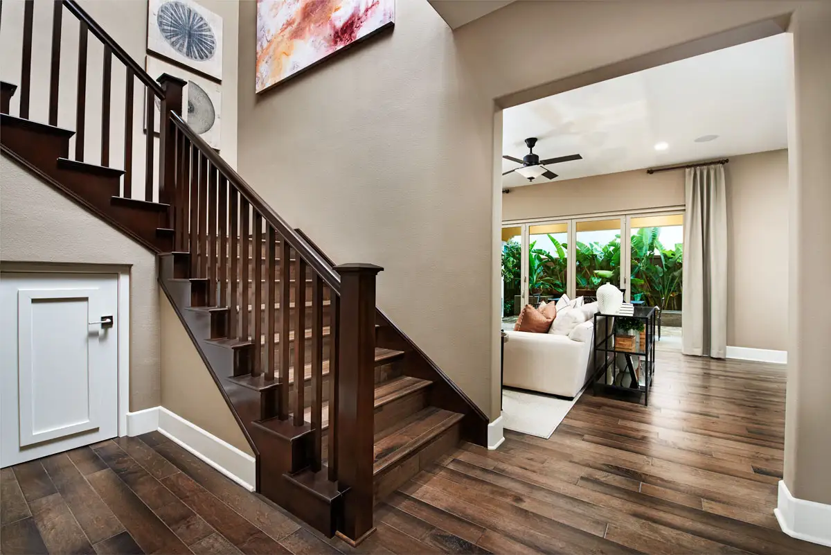 Stairwell to second floor with wood raillings and wood floors