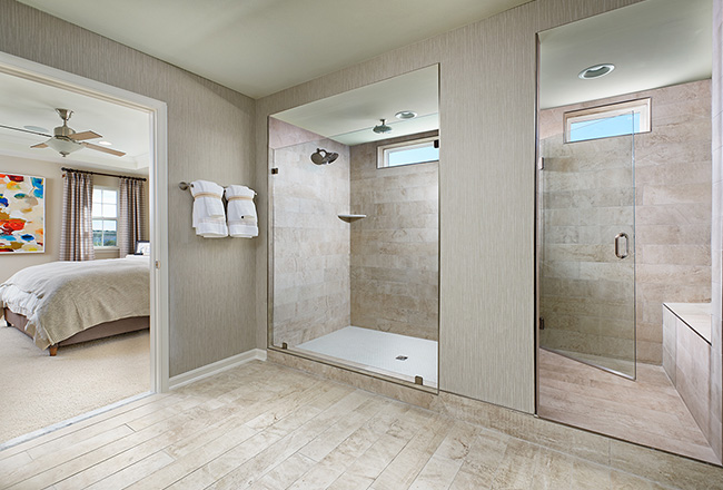 Large shower stall with two shower heads and seat
