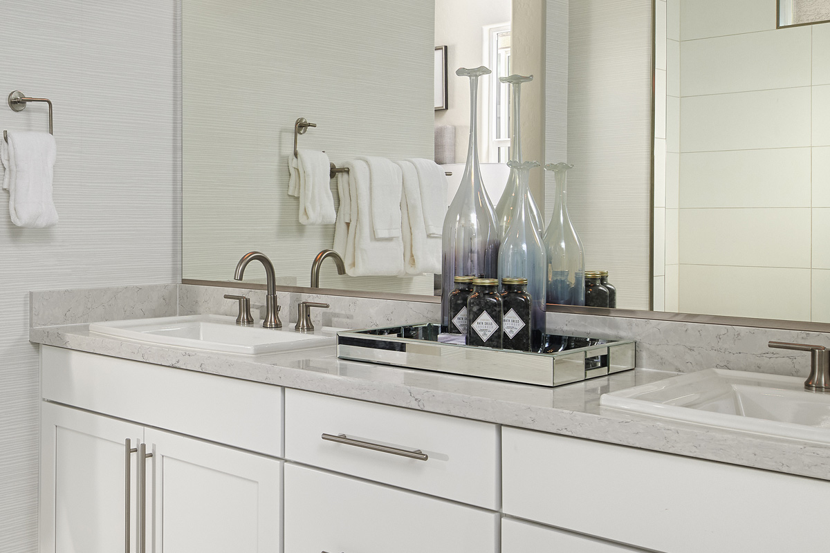 Double sink vanity below mirror with silver hardware