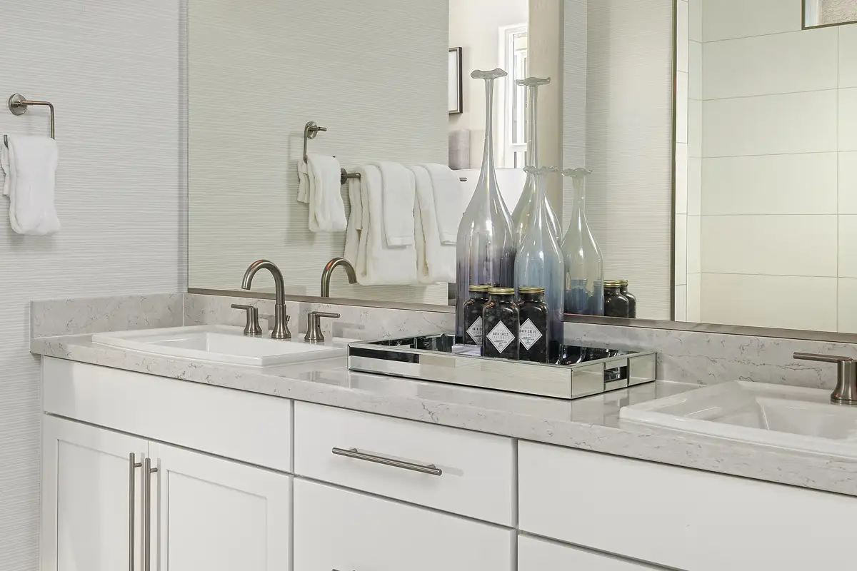 Double sink vanity below mirror with silver hardware