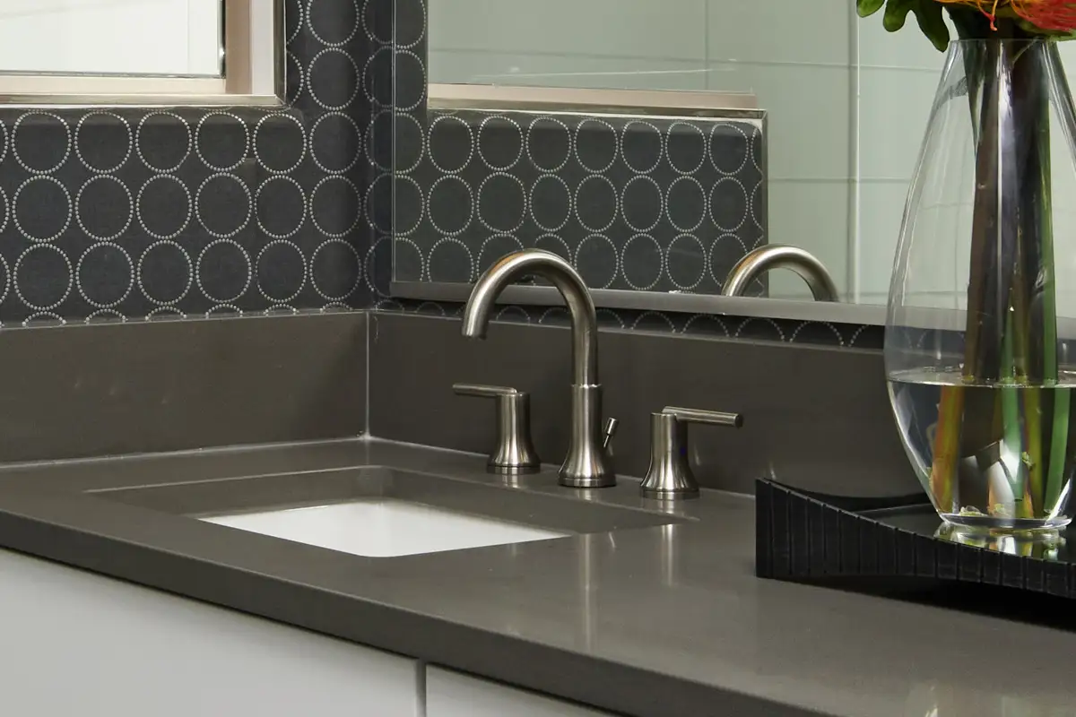 Dark bathroom countertop with silver hardware