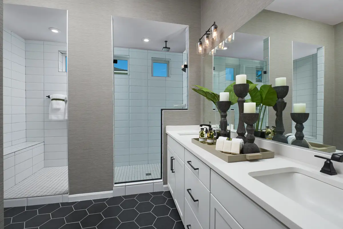 Bathroom vanity with two sinks and large shower stall with two showerheads and seat