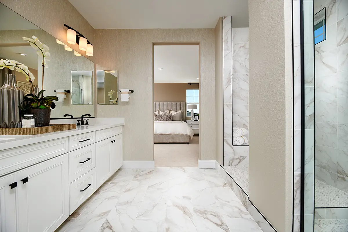 Bathroom with large white double sink vanity and step up to large shower stall