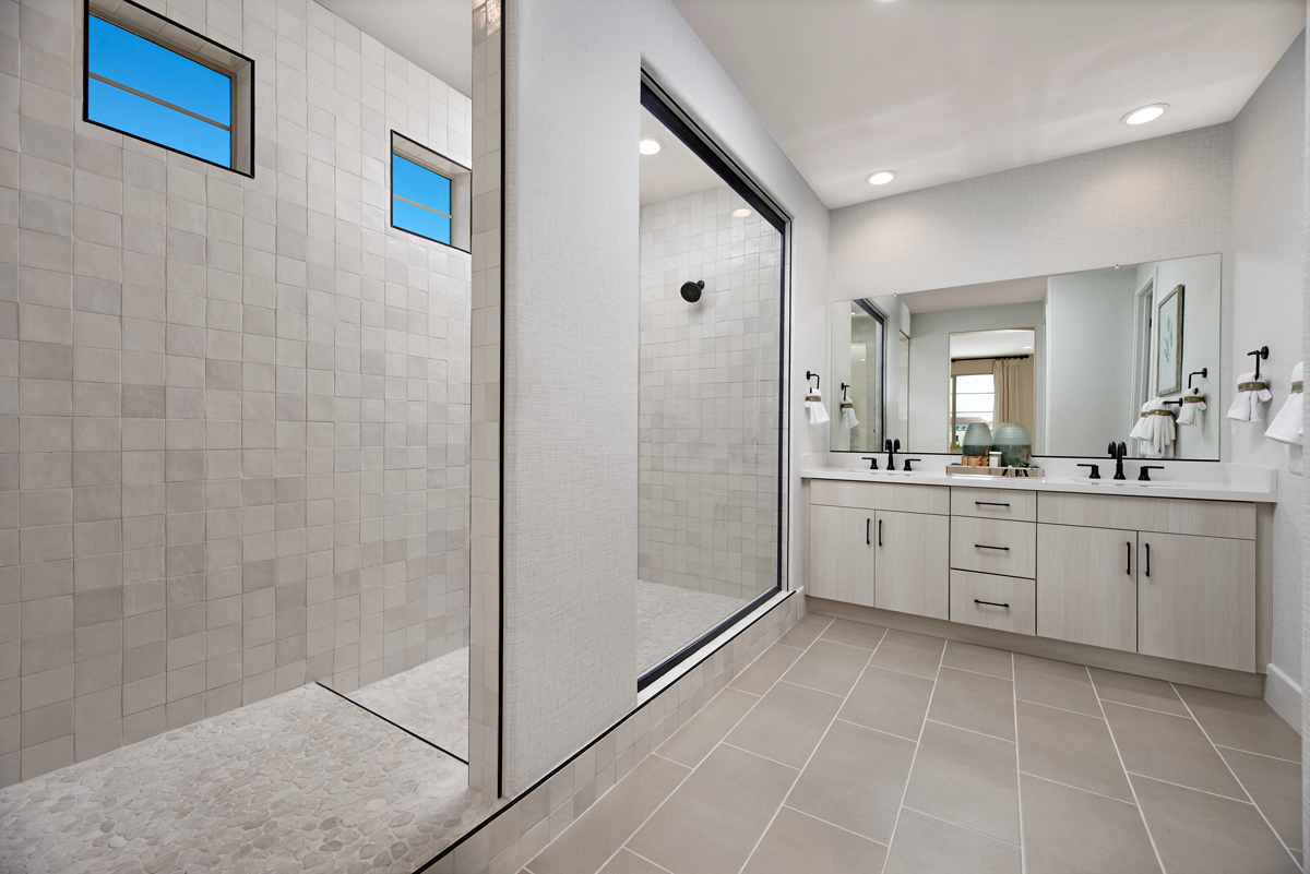 Bathroom with large stand up shower and medium square gray tiles