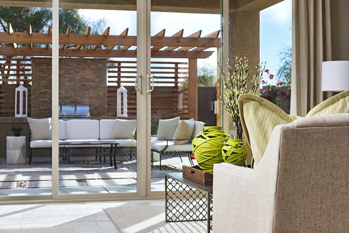 Sunroom with sliding doors showing pergola over outdoor seating