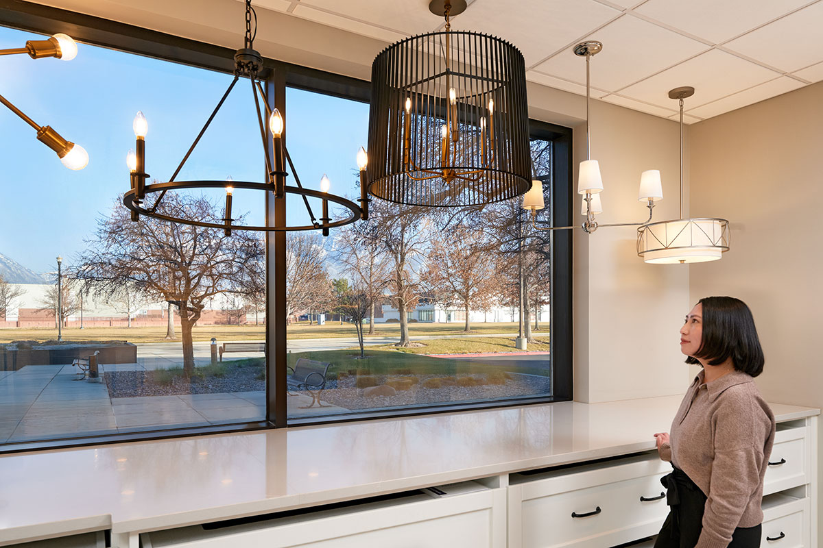 Woman at Home Gallery looking at lighting options