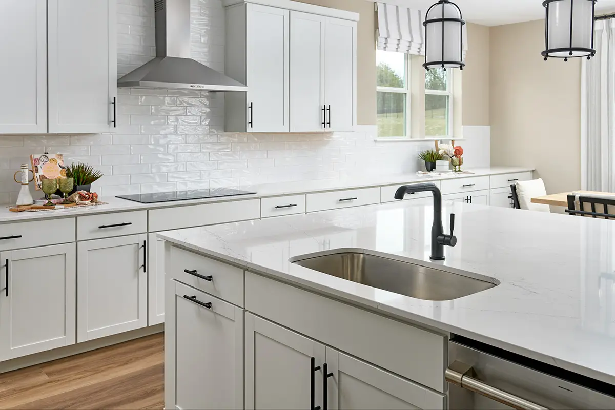 Sage floor plan kitchen with white cabinets and white countertops
